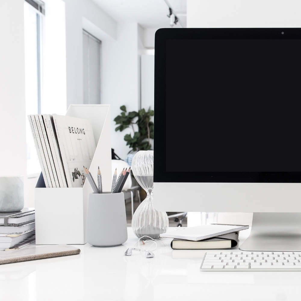 iMac on white desk with office accessories