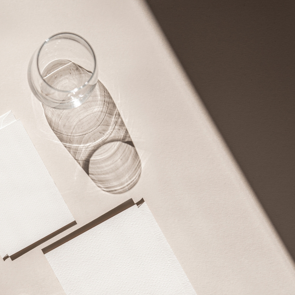 mockup glass water on cream desk