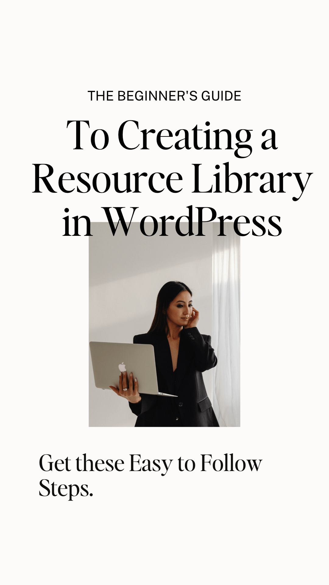 woman in black suite holding laptop